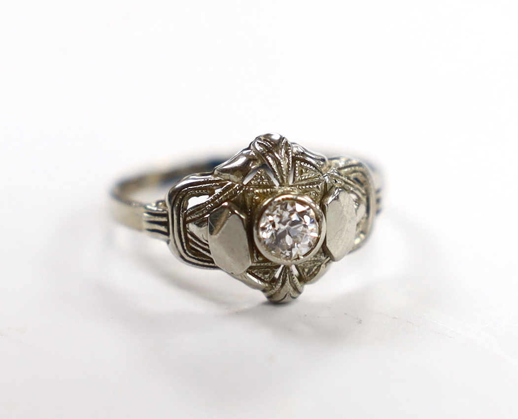 A 750 white metal and collet set solitaire diamond ring, size L, gross weight 1.5 grams.